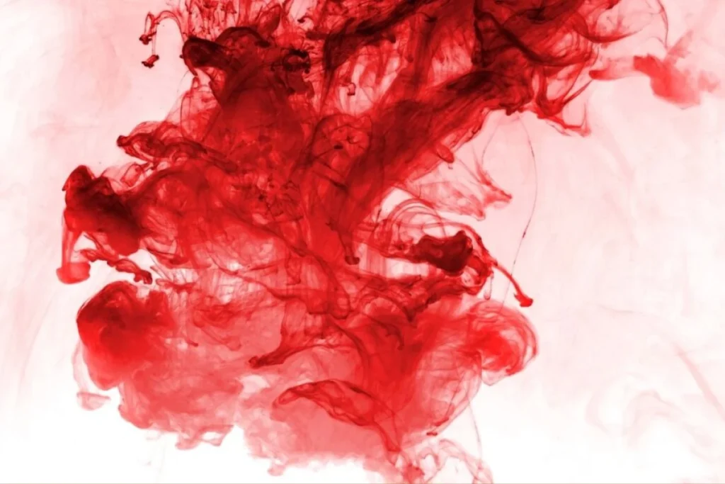An abstract visual representation of bright red fluid diffusing in water, metaphorically depicting blood in the stool or gastrointestinal bleeding.